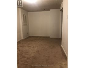 A room with carpeted floor and white walls.