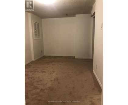 A room with carpeted floor and white walls.