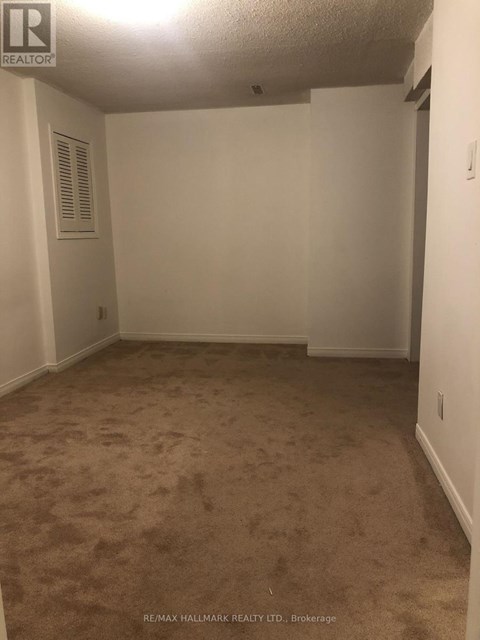 A room with carpeted floor and white walls.