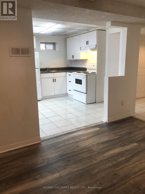 A kitchen with white cabinets and a black countertop.