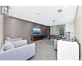 A living room with a grey couch and a television.