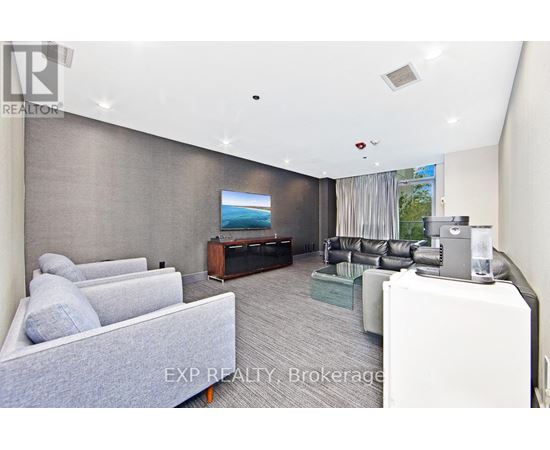 A living room with a grey couch and a television.