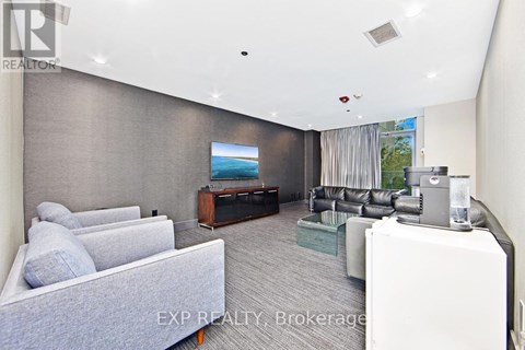 A living room with a grey couch and a television.