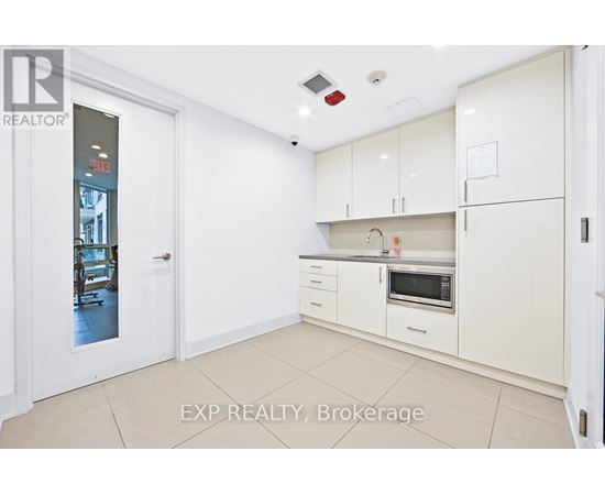 A white kitchen with EXP REALTY, Brokerage watermark.