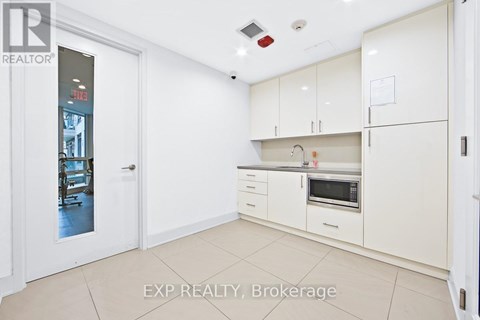 A white kitchen with EXP REALTY, Brokerage watermark.