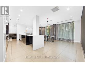 A spacious kitchen and dining area with white cabinets and a large island.