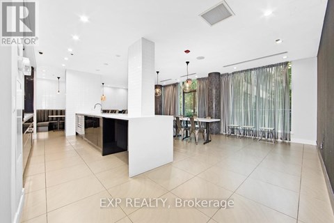 A spacious kitchen and dining area with white cabinets and a large island.