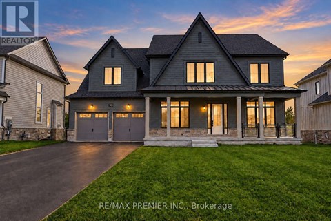 A large, modern house with a stone foundation and a large front porch.