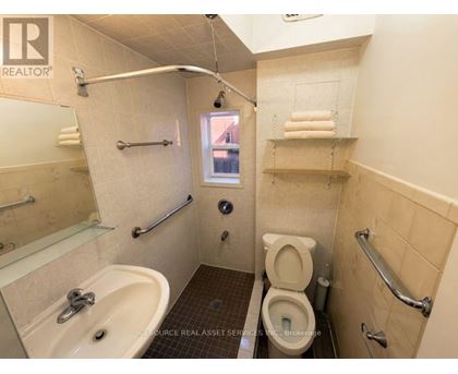 A bathroom with a toilet, sink, and shower.