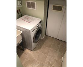 A white washer and dryer in a laundry room.