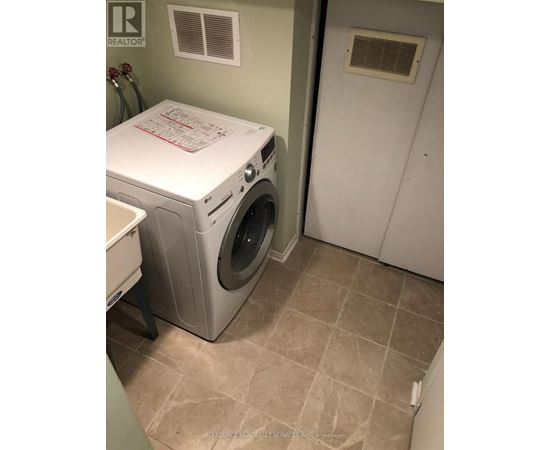 A white washer and dryer in a laundry room.