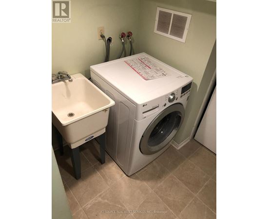 A white washer and dryer in a small laundry room.