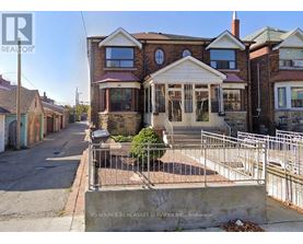 A house with a brick facade and a white porch is for sale.