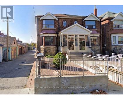 A house with a brick facade and a white porch is for sale.
