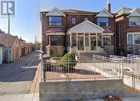 A house with a brick facade and a white porch is for sale.