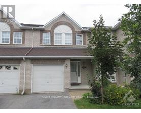 A house with a garage and a tree in front.