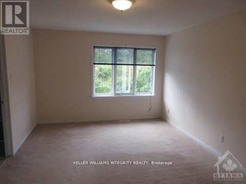 A room with a window and a sign that says "REALTOR".