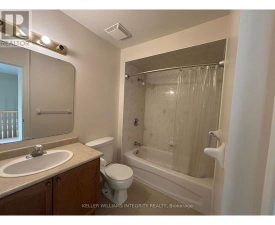 A bathroom with a toilet, sink, and bathtub.