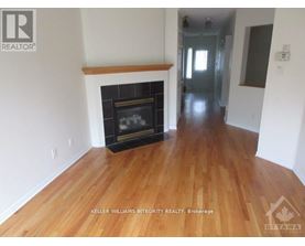 A room with a fireplace and wooden floors.