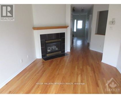 A room with a fireplace and wooden floors.