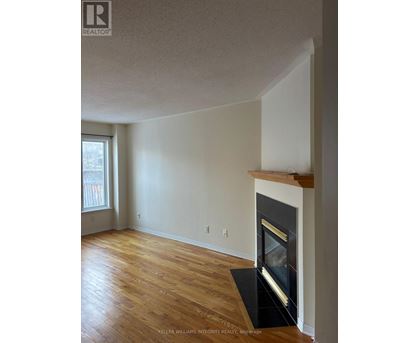 A room with a fireplace and a window.