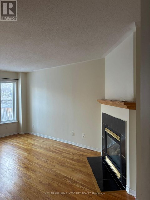 A room with a fireplace and a window.