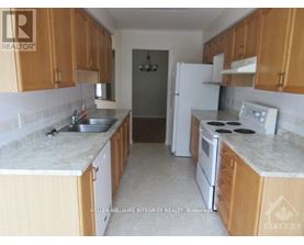 A kitchen with wooden cabinets and a white refrigerator.