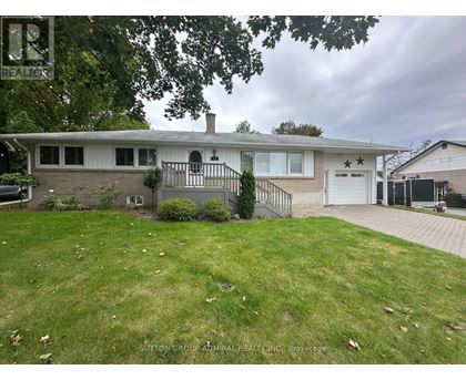 A house with a white garage door and a black gate.