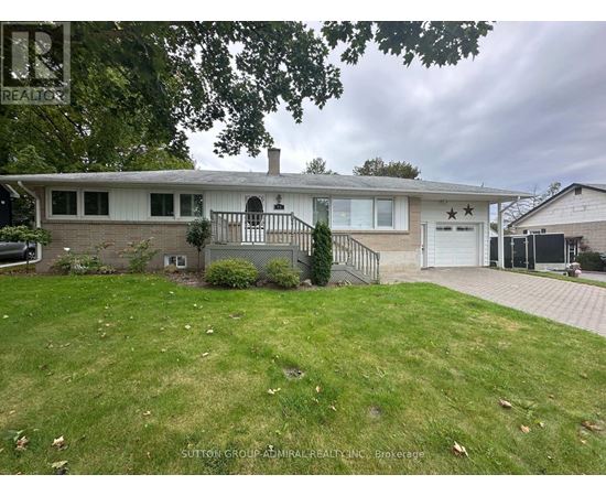 A house with a white garage door and a black gate.