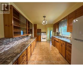 A kitchen with granite countertops and wooden cabinets.