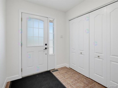 A white door with a black mat in front of it.
