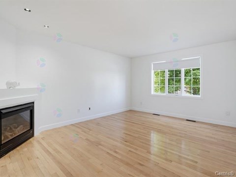 A room with a fireplace and a window.