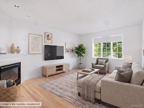A living room with a fireplace, a couch, a chair, a coffee table, and a television.