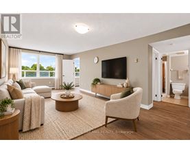 A living room with a couch, chair, and television.