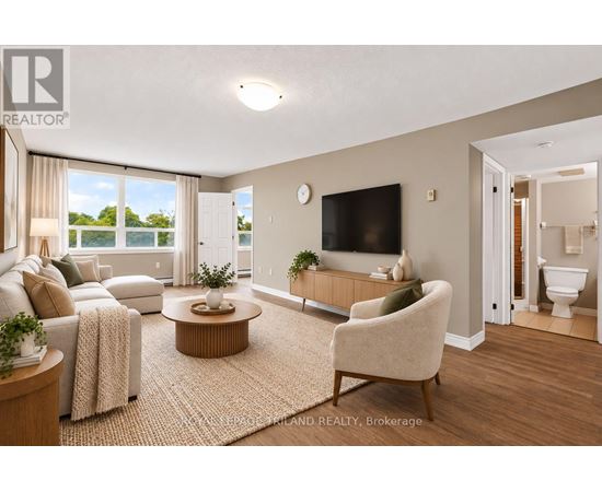 A living room with a couch, chair, and television.