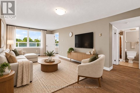 A living room with a couch, chair, and television.