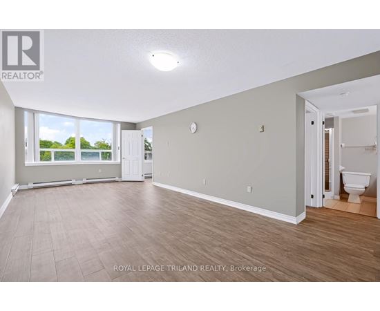 A spacious room with a door leading to another room.