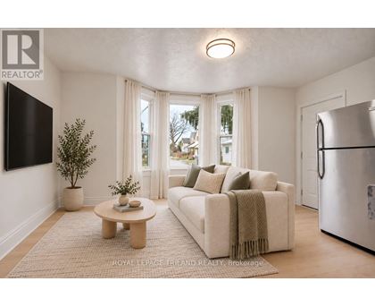 A living room with a couch, a coffee table, and a television.