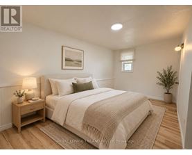 A bedroom with a bed, nightstand, and lamp.
