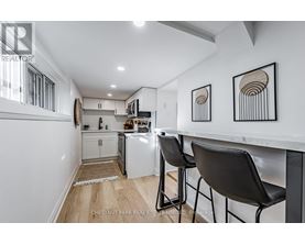 A kitchen with white cabinets and a white counter top.