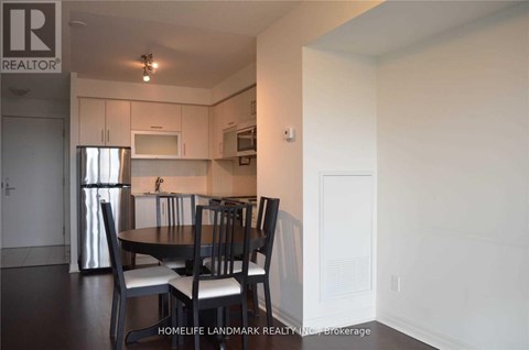A kitchen with a table and chairs in the foreground.