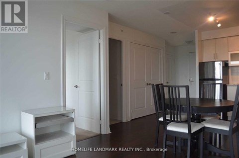 A dining area with a table and chairs.