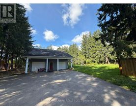 A residential property with a detached garage and a driveway.