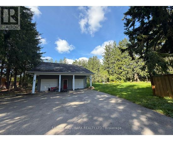 A residential property with a detached garage and a driveway.