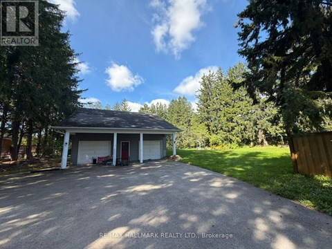 A residential property with a detached garage and a driveway.