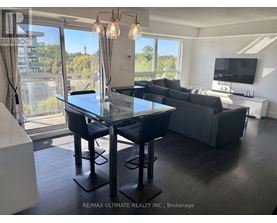 A modern dining room with a glass table and chairs.