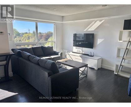 A living room with a grey couch and a television.