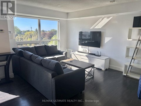 A living room with a grey couch and a television.