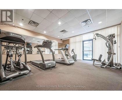 A gym with treadmills, elliptical machines, and a weight machine.