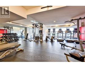 A gym with a variety of equipment including treadmills, weights, and exercise machines.